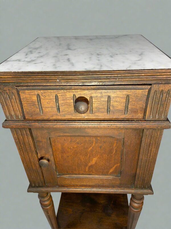 Antique French marble-top cabinet from late 19th century with provincial style turned legs and solid wood construction