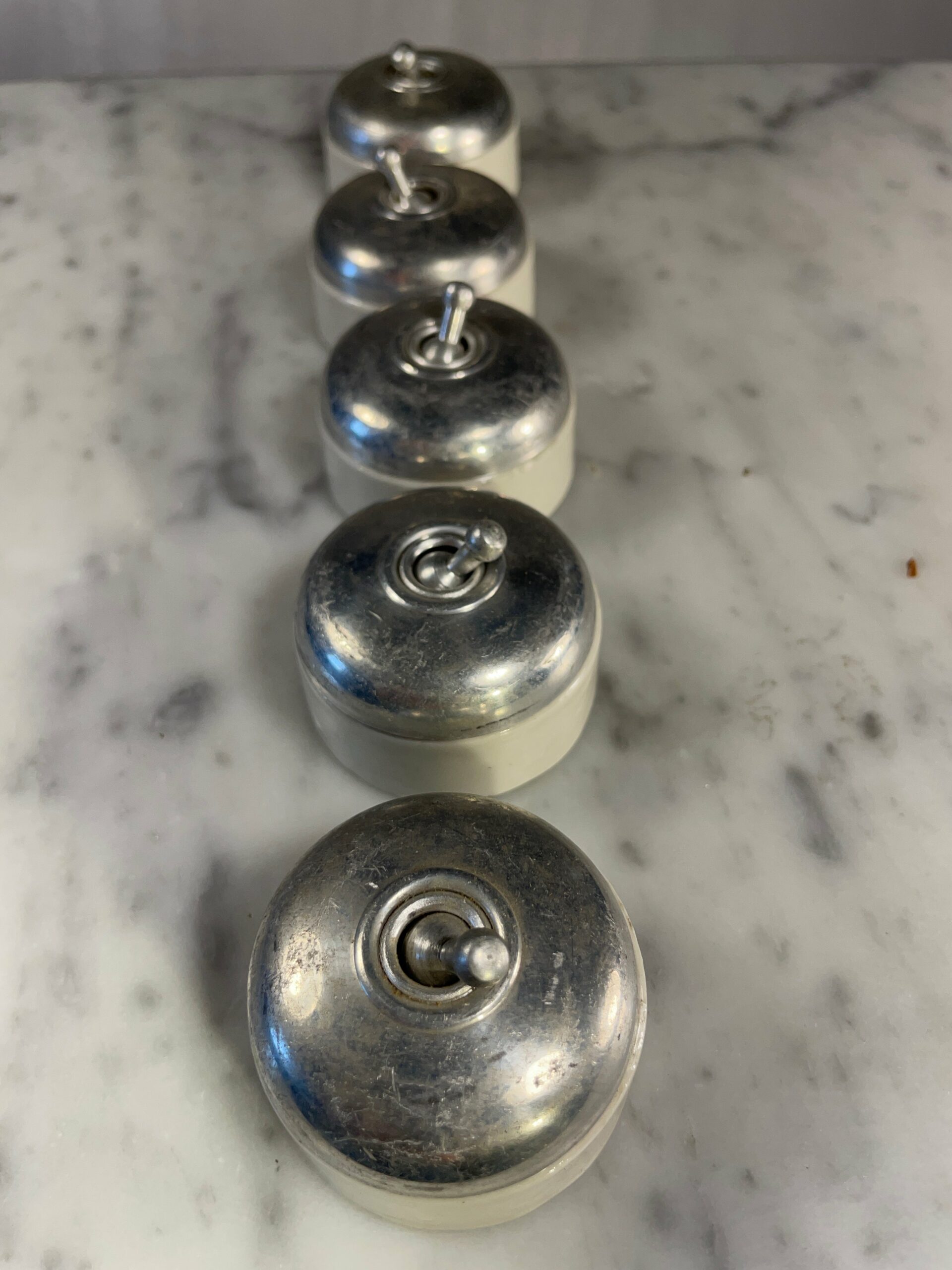 Vintage mid-century porcelain and chrome toggle light switch with industrial design from 1950s-1970s European homes