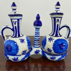 Vintage hand-painted blue and white ceramic oil and vinegar cruet set with folk art floral designs - mid-20th century kitchen collectible
