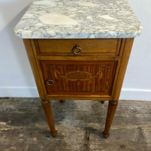 Antique Louis XVI-style nightstand with white marble top and intricate marquetry inlay, late 19th century French bedside cabinet with brass ring pulls