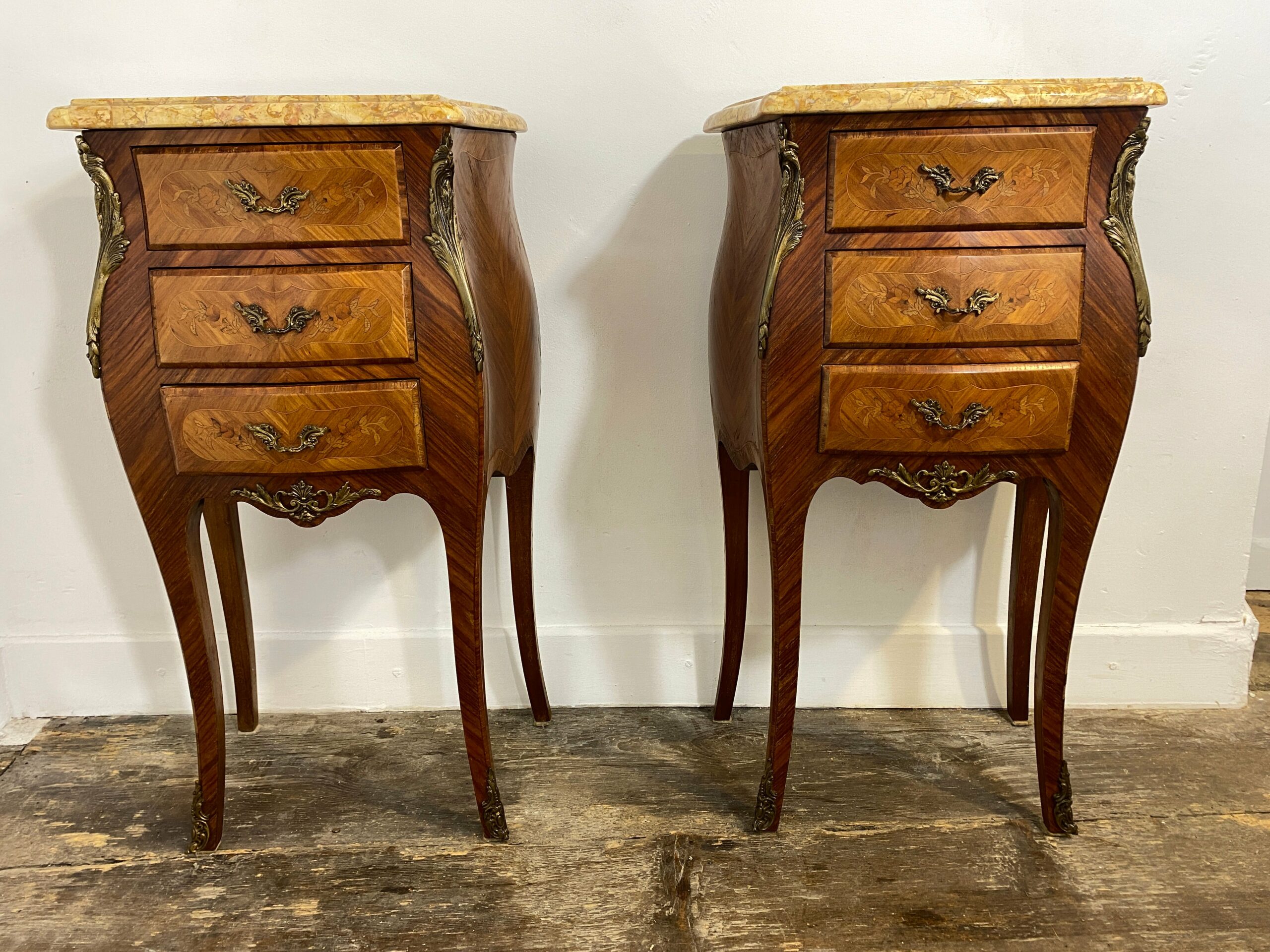 Pair of Louis XV-style bedside cabinets with veined marble tops, Rococo bombé shape design with marquetry inlays and ormolu mounts, mid-20th century French nightstands